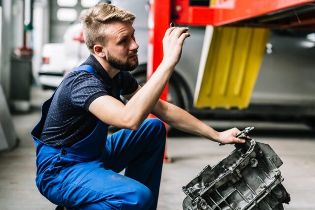 Mechanic repairing truck engine